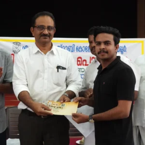 Adhil Noushad receiving a cash award from MES Asmabi College Principal Biju during an event, best graphic designer in Kerala