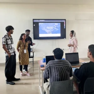 Stage still of Adhil Noushad during design workshop event at KMEA Engineering College, best graphic designer in Kerala