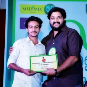 Adhil Noushad receiving certificate from TV serial actor Sharran Puthumana, best graphic designer in Kerala